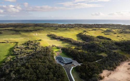 an aerial view of a house on a golf course at The Retreat at St Andrews Beach Golf Course in Fingal