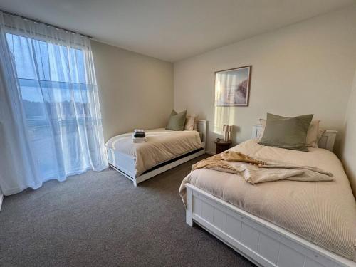 Ένα ή περισσότερα κρεβάτια σε δωμάτιο στο The Retreat at St Andrews Beach Golf Course