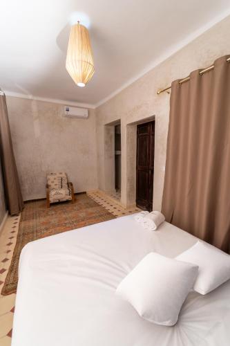 a bedroom with a large white bed in a room at Riad Lalla Fatima Marrakech in Marrakesh