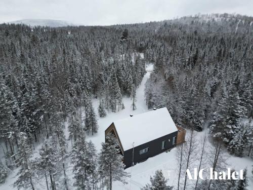 a barn in the middle of a snow covered forest at BLOOM - Luxe et Confort en forêt in Valcartier Station