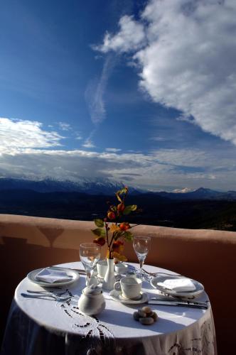 a table with a white table cloth and glasses on it at Konitsa Mountain Hotel in Konitsa