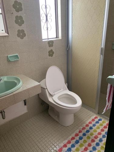 a bathroom with a toilet and a sink at Casa Dos Hermanas in Guanajuato