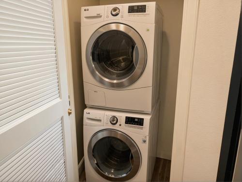 a washer and a dryer in a room at Glamorous KTown Boutique Residences with Rooftop view in Los Angeles