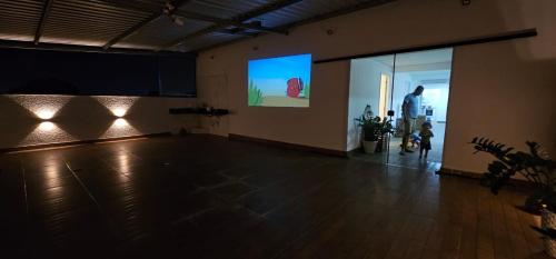 a room with a dance floor with a man standing in it at Dima's in Porto Seguro