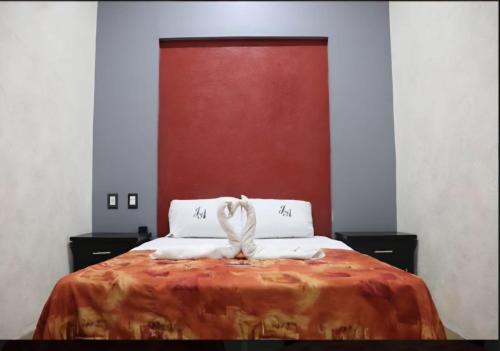 a bedroom with a bed with two towels on it at J Alejandro - Centro Histórico Guadalajara in Guadalajara