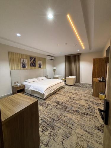 a large bedroom with a bed and a large rug at واحه فدك للشقق المخدومه in Al Ḩāyiţ