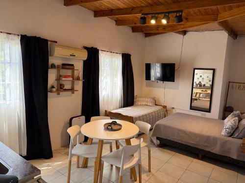 a bedroom with a table and a bed and a table and chairs at Merlo ink3 in Merlo