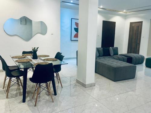 a living room with a table and a couch at Vienna manilla court in Lagos