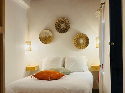 a bedroom with a bed with a pillow on it at Riad Sultanes in Essaouira