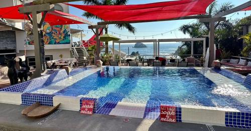 a large swimming pool with a view of the ocean at Villa Aikia (Adults Suites A/C) in Zipolite
