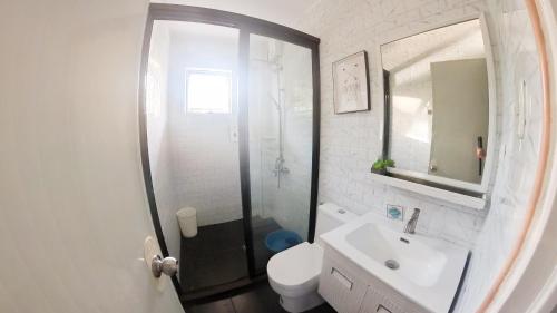 a bathroom with a shower and a toilet and a sink at Sacaan Tropical Breeze Resort in Sogod