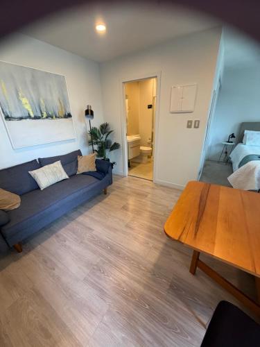 a living room with a couch and a table at Central City Prime-next to SKY in Auckland