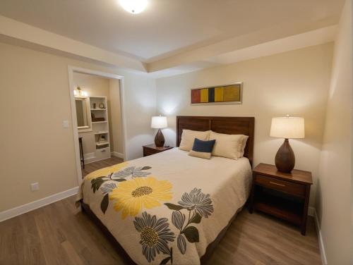 a bedroom with a bed with a floral bedspread at Glamorous KTown Boutique Residences with Rooftop view in Los Angeles