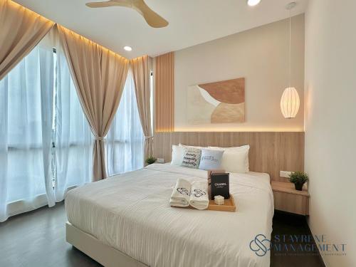 a bedroom with a bed with two towels on it at SKS Pavillion Residences by Stayrene in Johor Bahru