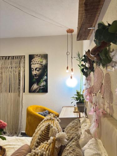 a room with a couch and a table and a picture of a woman at Boho chic, fresh, modern apartment in Ixtapa