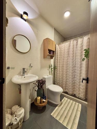 a bathroom with a sink and a toilet and a shower at Boho chic, fresh, modern apartment in Ixtapa