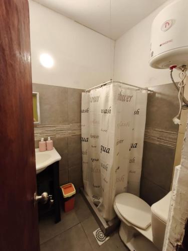 a bathroom with a shower and a toilet and a sink at Libertador 7 MVD in Montevideo