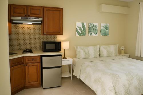a small room with a bed and a kitchen at Island Retreat Studio #4 in Nassau