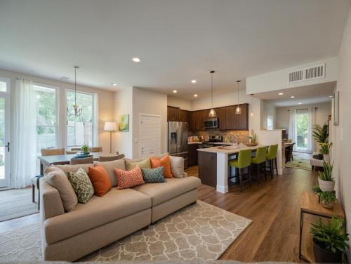 a living room with a couch and a kitchen at Glamorous KTown Boutique Residences with Rooftop view in Los Angeles