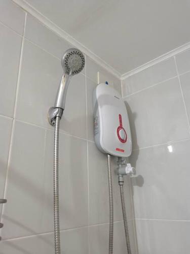 a shower with a blow dryer in a bathroom at KozySpace in Davao City