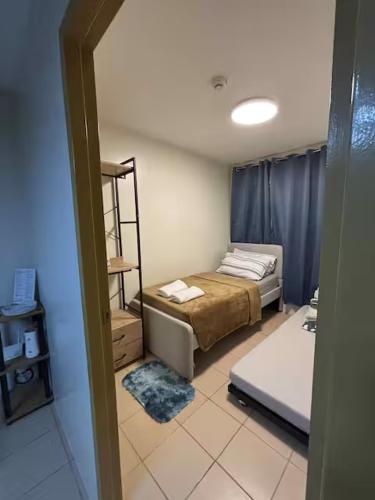 a room with a bed and a room with two beds at KozySpace in Davao City