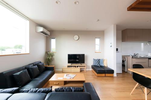 a living room with a couch and a table at Kotohaku 木津町 in Kizugawa