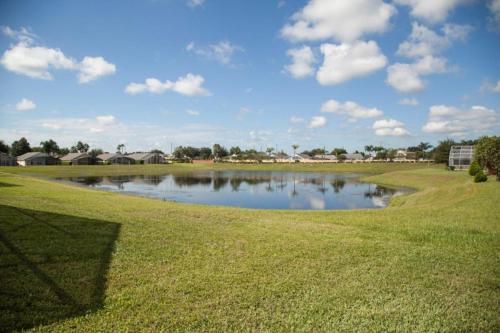 a pond on the side of a golf course at Simba's Lake House in Orlando
