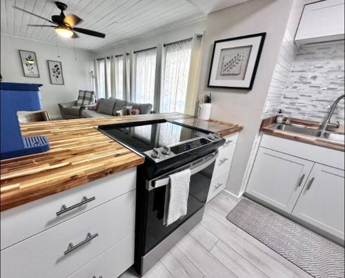 a kitchen with a stove and a counter top at Sunlit Sands Destin Condo in Destin