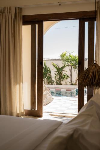 a bedroom with an open door to a patio at Teddies in Ahangama