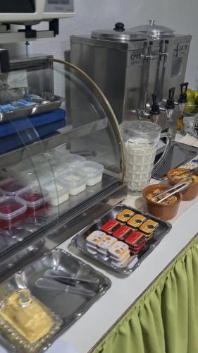 a buffet line with food in a restaurant at Hotel Brivanna in Campo Grande