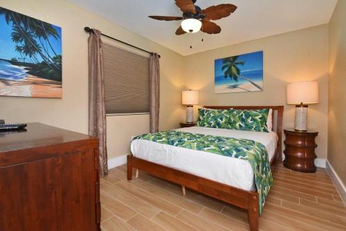 a bedroom with a bed and a ceiling fan at Pacific Shores B102 · PacSB102 Family Getaway 3BD Across Beach in Kihei
