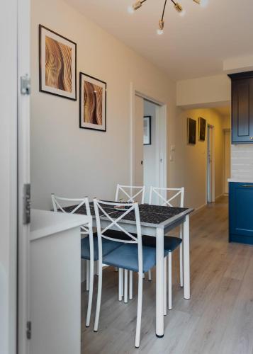 a kitchen and dining room with a table and chairs at LuxCity Apartment in the Center of Nowy Targ, FREE PARKING in Nowy Targ