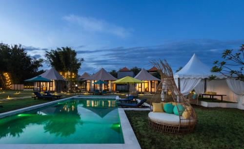 a resort with a swimming pool and some tents at Wildflower Entire Estate in Ungasan