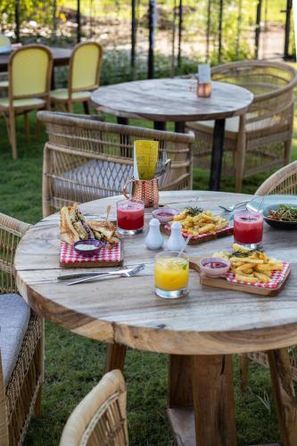 Una mesa de madera con comida y bebidas encima. en Wildflower Entire Estate, en Ungasan