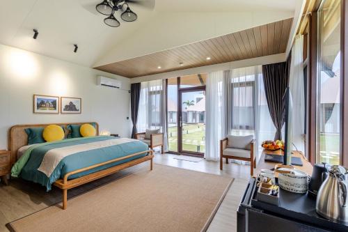 a bedroom with a bed and a large window at Wildflower Entire Estate in Ungasan