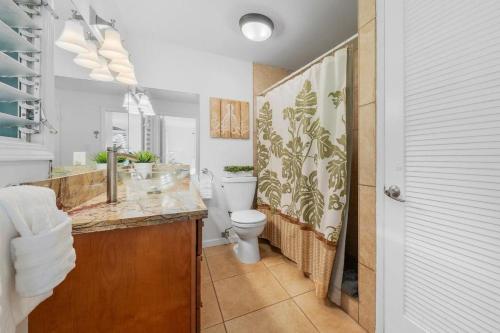 a bathroom with a toilet and a sink at International Colony Club 37 · ICC 37 Remodeled Hawaiian Cottage in Kaanapali