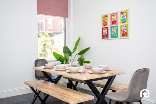 a dining room table with chairs and a wooden table at Vacant Nests The Fredrick Close to sea front in Seaham