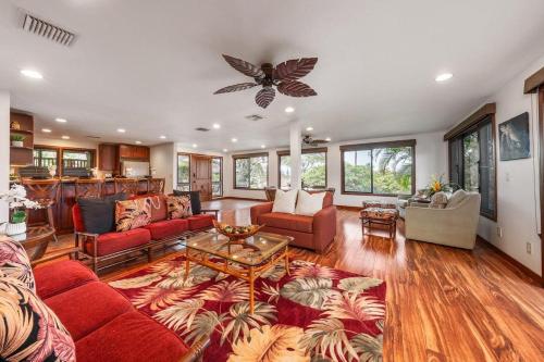 a living room with red furniture and a butterfly ceiling at International Colony Club 23 · ICC 23 3BD Kaanapali Plantation C in Lahaina