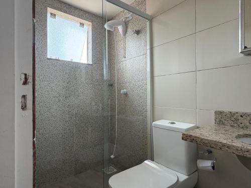 a bathroom with a shower and a toilet and a sink at Moradas Desterro, próximo ao aeroporto 01 in Florianópolis