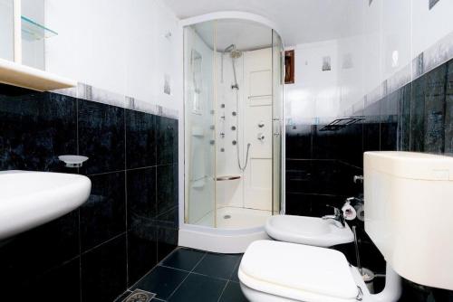 a bathroom with a shower and a toilet and a sink at Brescia villa - Your Private Escape in matara in Gandara West