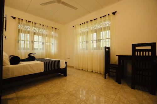 a bedroom with a black cat sitting on a bed at Brescia villa - Your Private Escape in matara in Gandara West