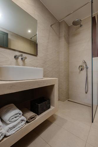 a bathroom with a sink and a shower at Adelda Villa in Kypseli
