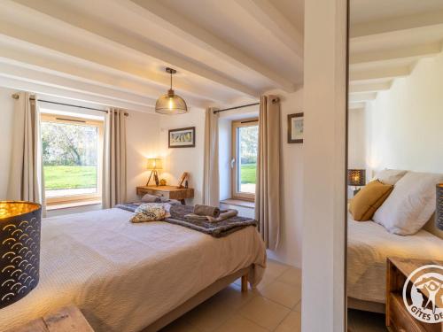 a bedroom with a bed and a window at Gîte confortable à la campagne, 2 chambres, vue dégagée - FR-1-622-118 in Le Vieil-Baugé
