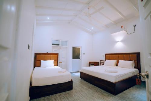 Postel nebo postele na pokoji v ubytování Kami Unawatuna