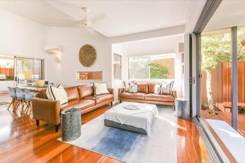 a living room with a couch and a table at Allure Stradbroke Resort in Point Lookout