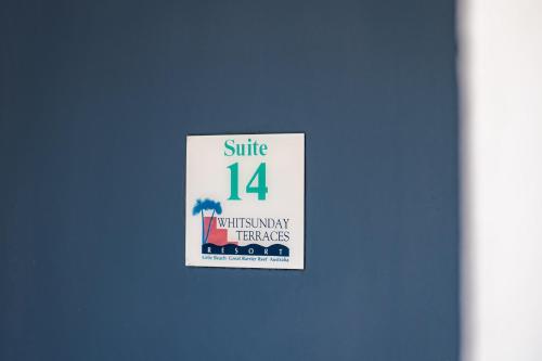 a sign that says smile with many benefits at Ocean View Apartment 14 in Airlie Beach