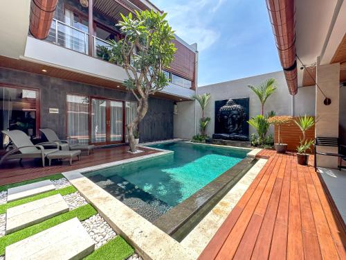 a swimming pool in the backyard of a house at Foursons Villa in Denpasar