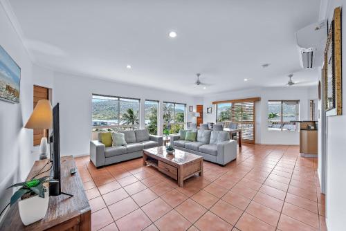 a living room with couches and a table at Spa Haven 17A in Airlie Beach