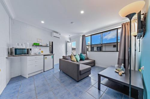 a living room with a couch and a table at Airlie Sun & Sand Accommodation #5 in Airlie Beach