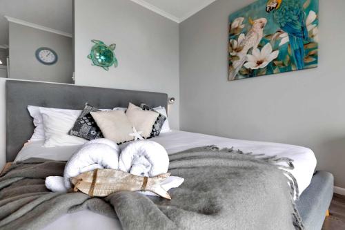 a bedroom with a bed with stuffed animals on it at Ocean View 16A Studio Pool & Spa Wi-Fi in Airlie Beach